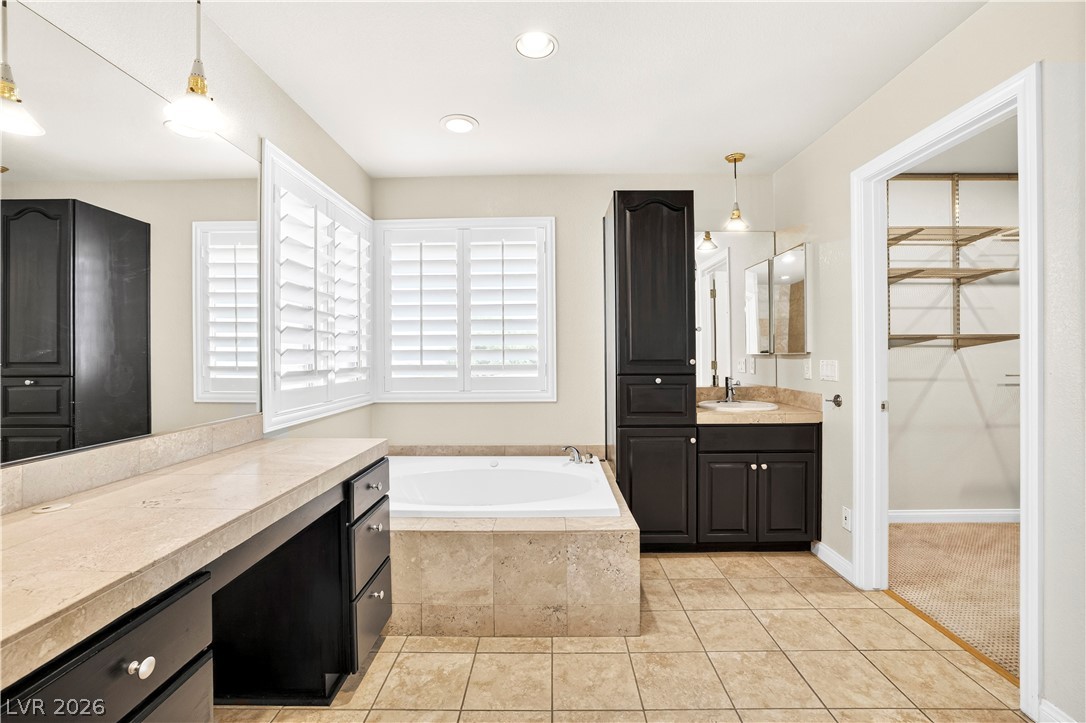 1135 Calico Ridge Drive Henderson, NV 89011 - Photo 35 of 86 Luxurious bathing retreat boasts an inviting soaking tub and spacious vanity with ample storage.