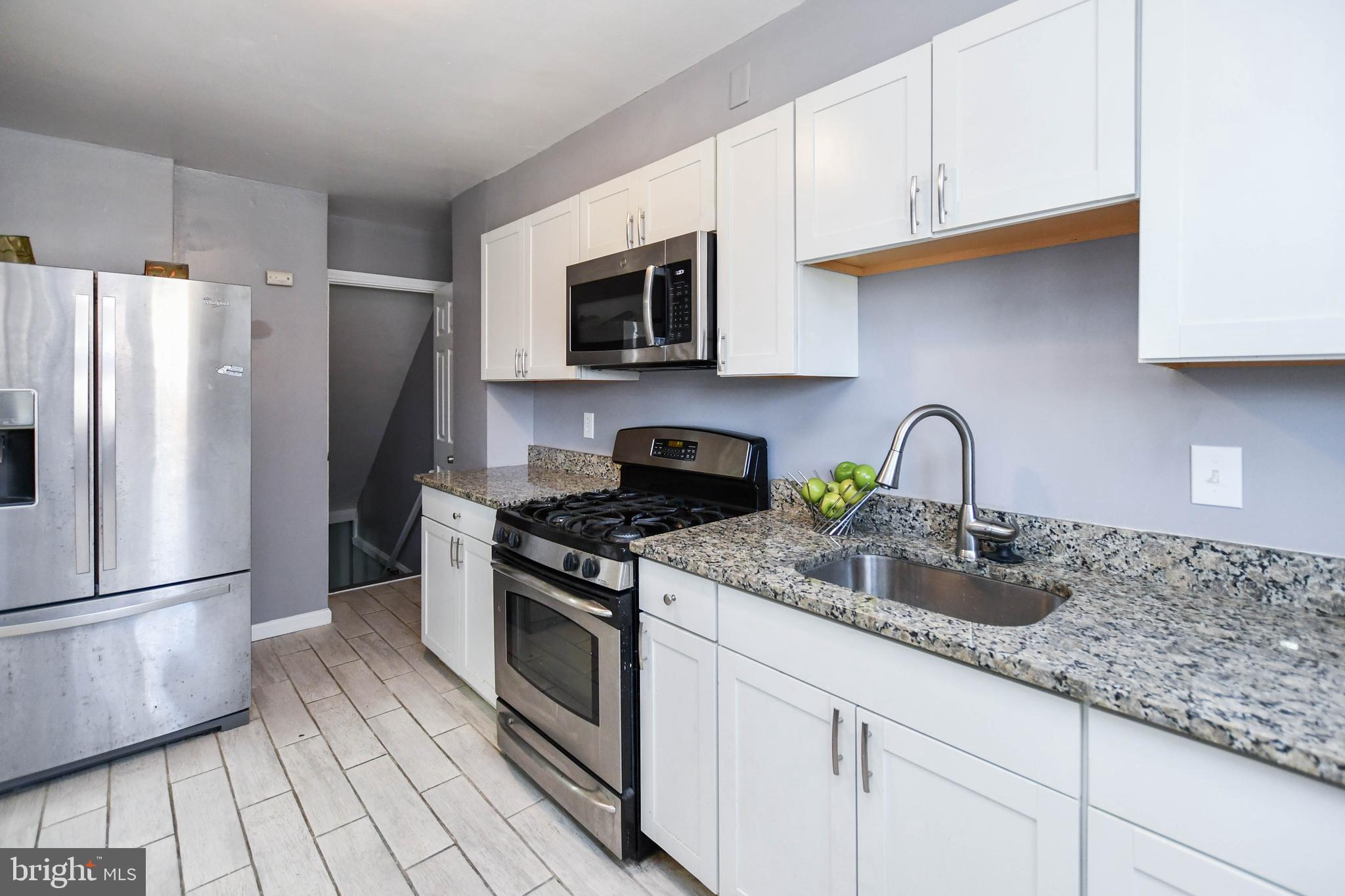 1028 Evesham Avenue Baltimore, MD 21212 - Photo 21 of 49 a kitchen with stainless steel appliances granite countertop a refrigerator sink and stove