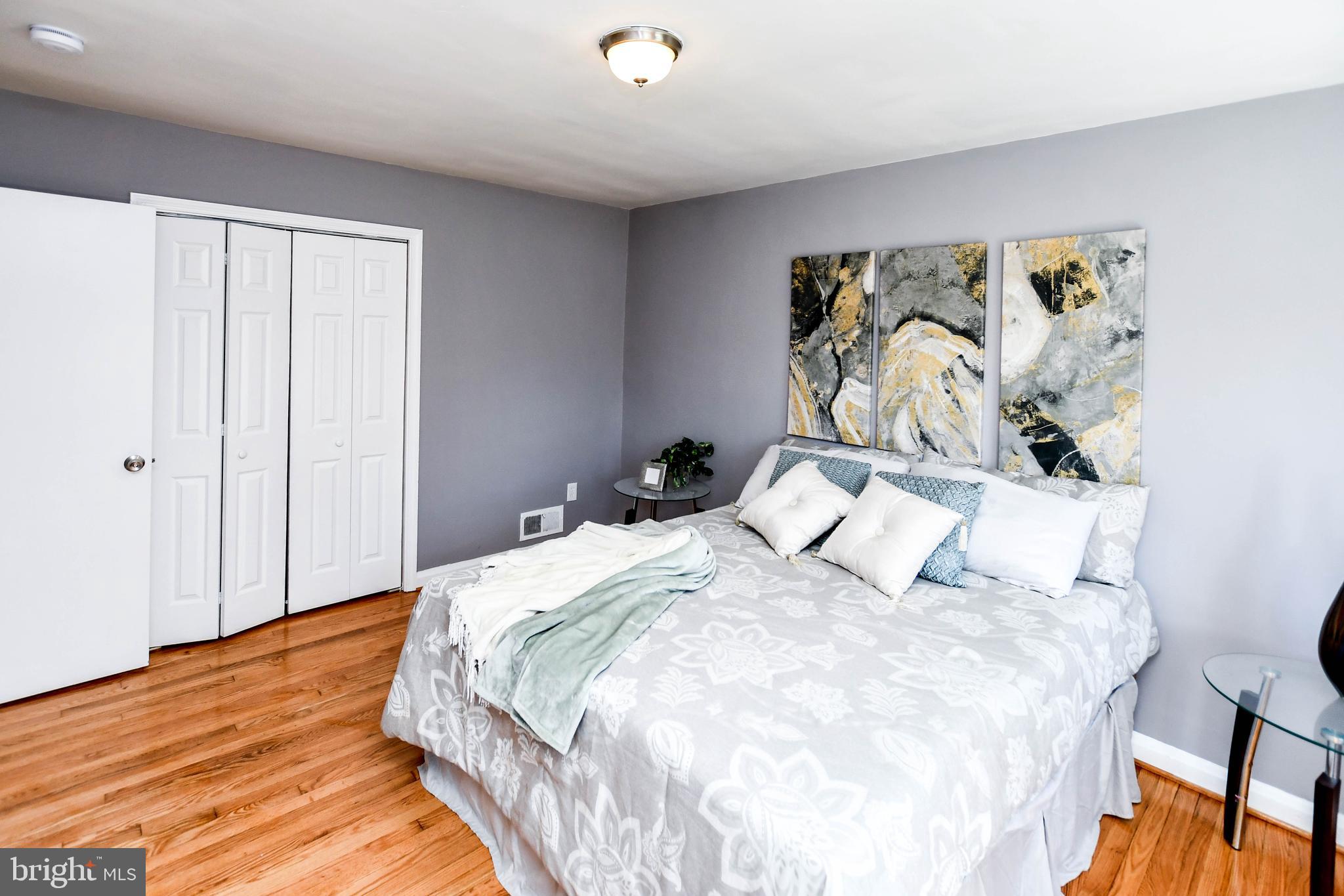 1028 Evesham Avenue Baltimore, MD 21212 - Photo 25 of 49 a bedroom with a bed and wooden floor