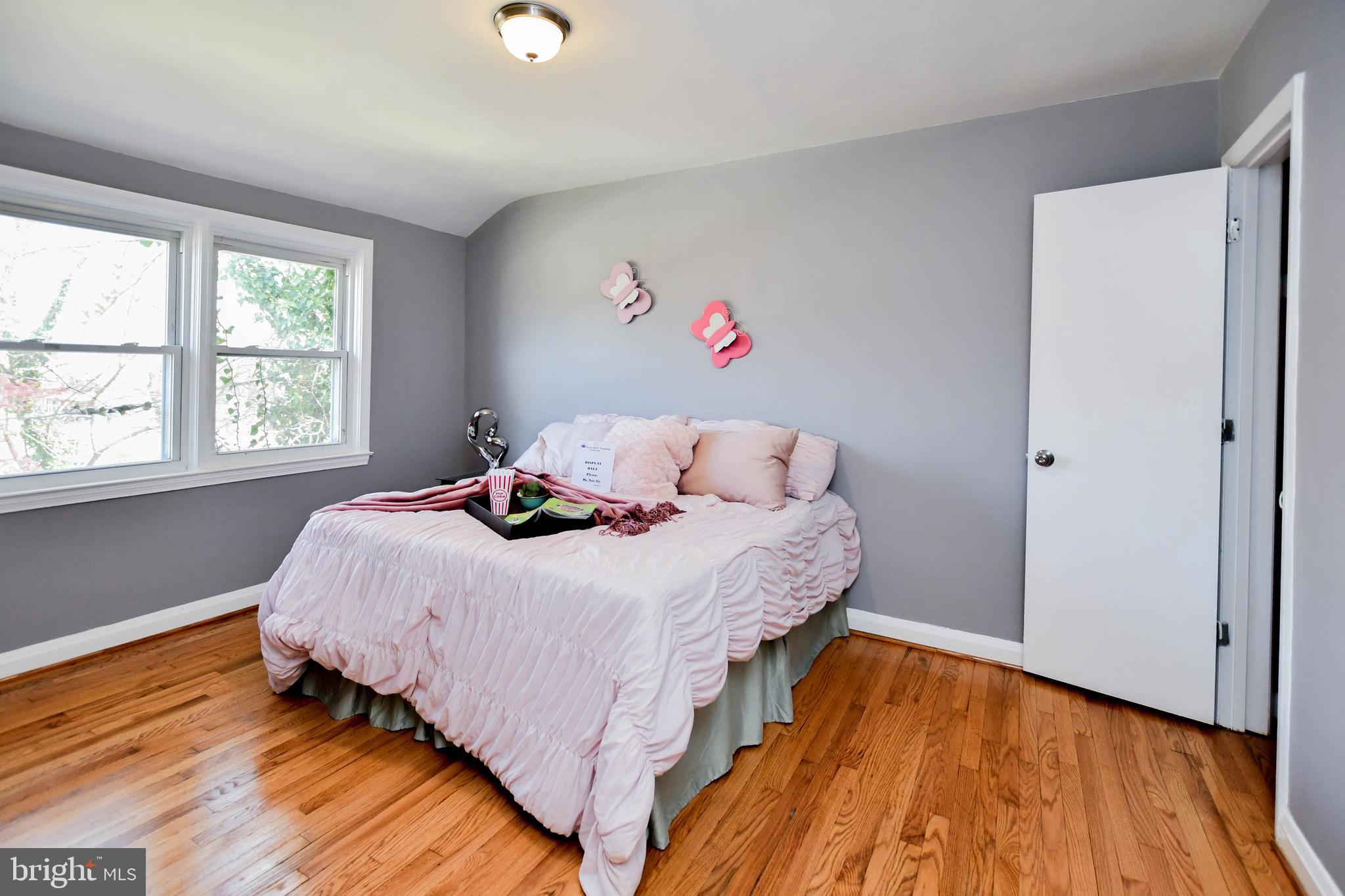 1028 Evesham Avenue Baltimore, MD 21212 - Photo 27 of 49 a bedroom with a bed and wooden floor