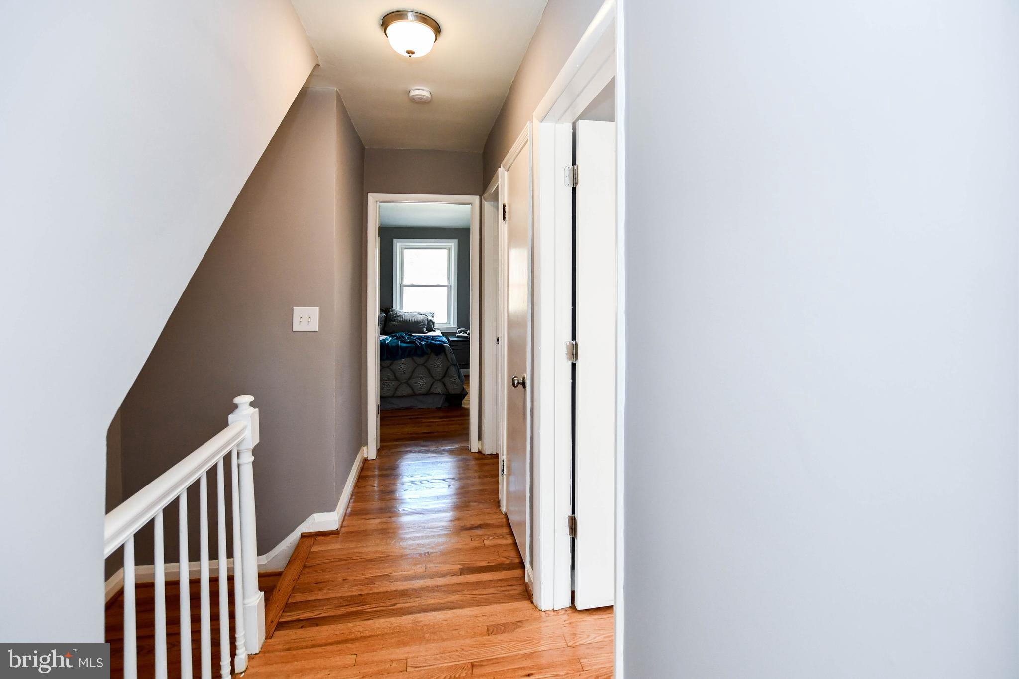 1028 Evesham Avenue Baltimore, MD 21212 - Photo 35 of 49 a view of a hallway with wooden floor and staircase