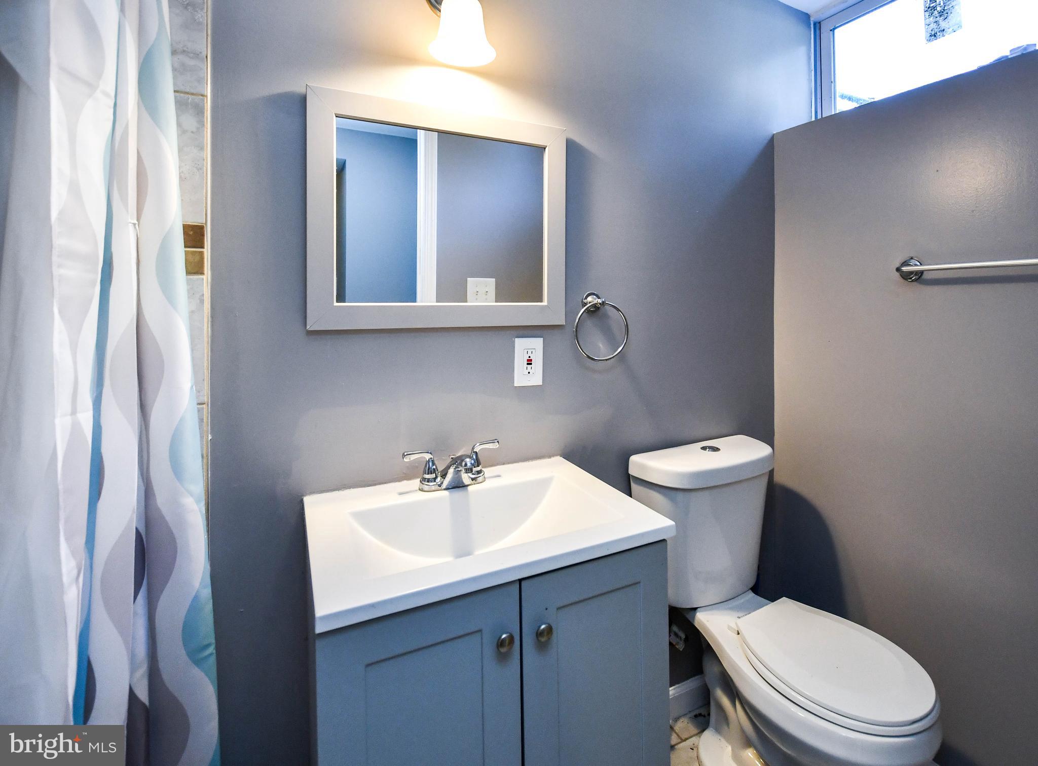 1028 Evesham Avenue Baltimore, MD 21212 - Photo 46 of 49 a white toilet sitting next to a bathroom sink