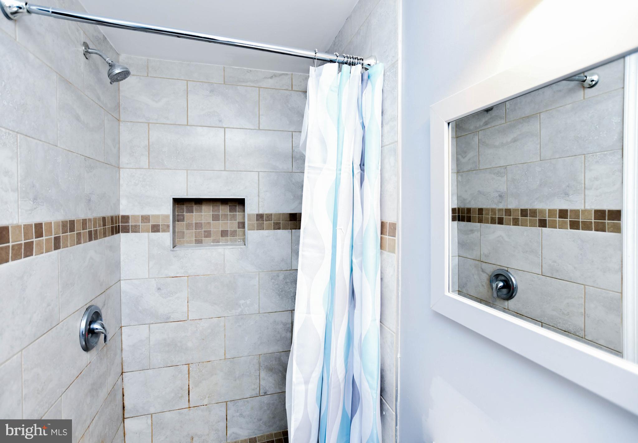 1028 Evesham Avenue Baltimore, MD 21212 - Photo 47 of 49 a bathroom with a shower and a tub