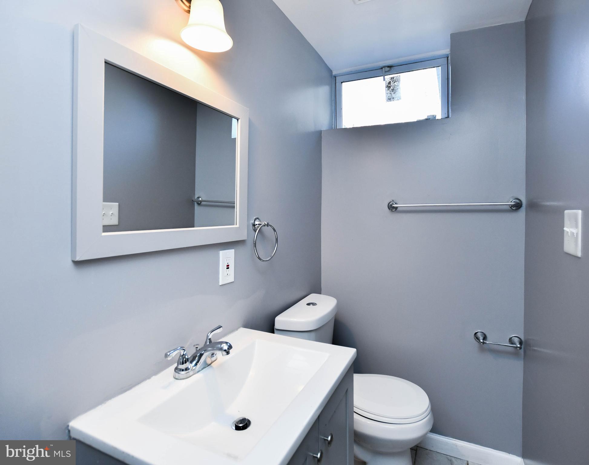 1028 Evesham Avenue Baltimore, MD 21212 - Photo 48 of 49 a bathroom with a sink mirror and toilet