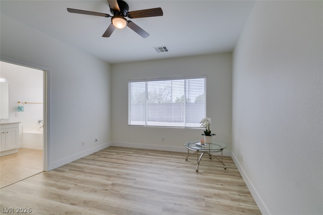 10959 Pumpkin Ridge Avenue Las Vegas, NV 89135 - Photo 25 of 51 A quiet bedroom with light wood-style flooring and a refreshing ceiling fan are the key elements of your future master bedroom.