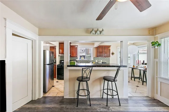 a view of a a dining room with furniture window and wooden floor