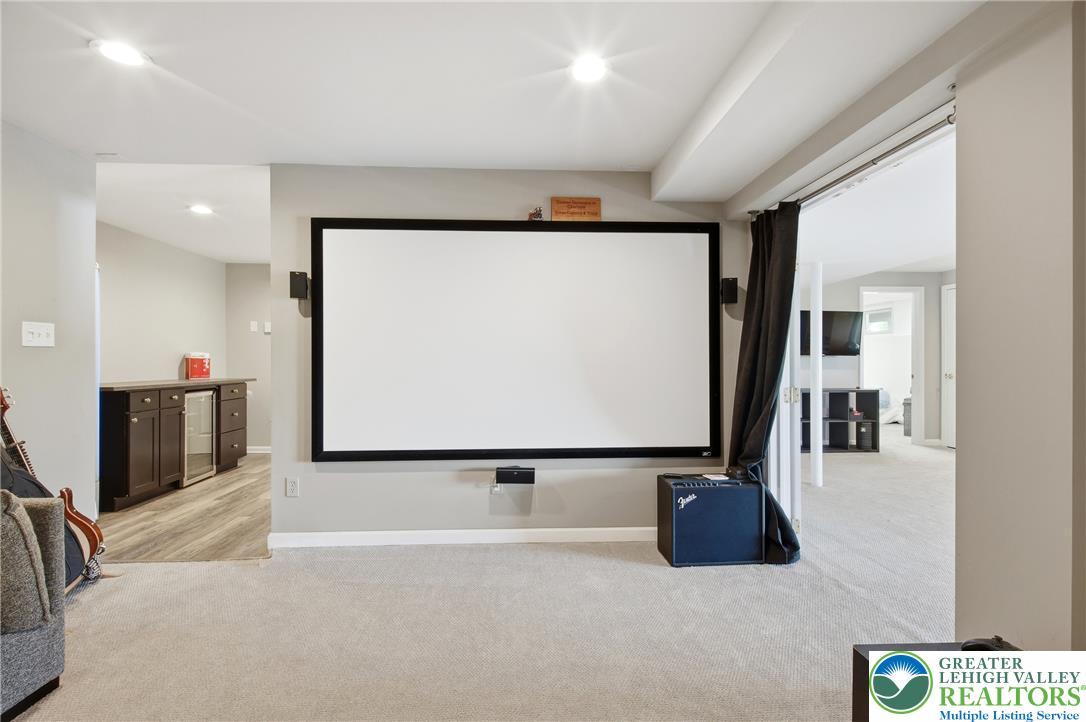 115 West Butternut Road Hellertown, PA 18055 - Photo 56 of 97 A dedicated home theater room with a large projection screen and built-in bar area offers entertainment possibilities.
