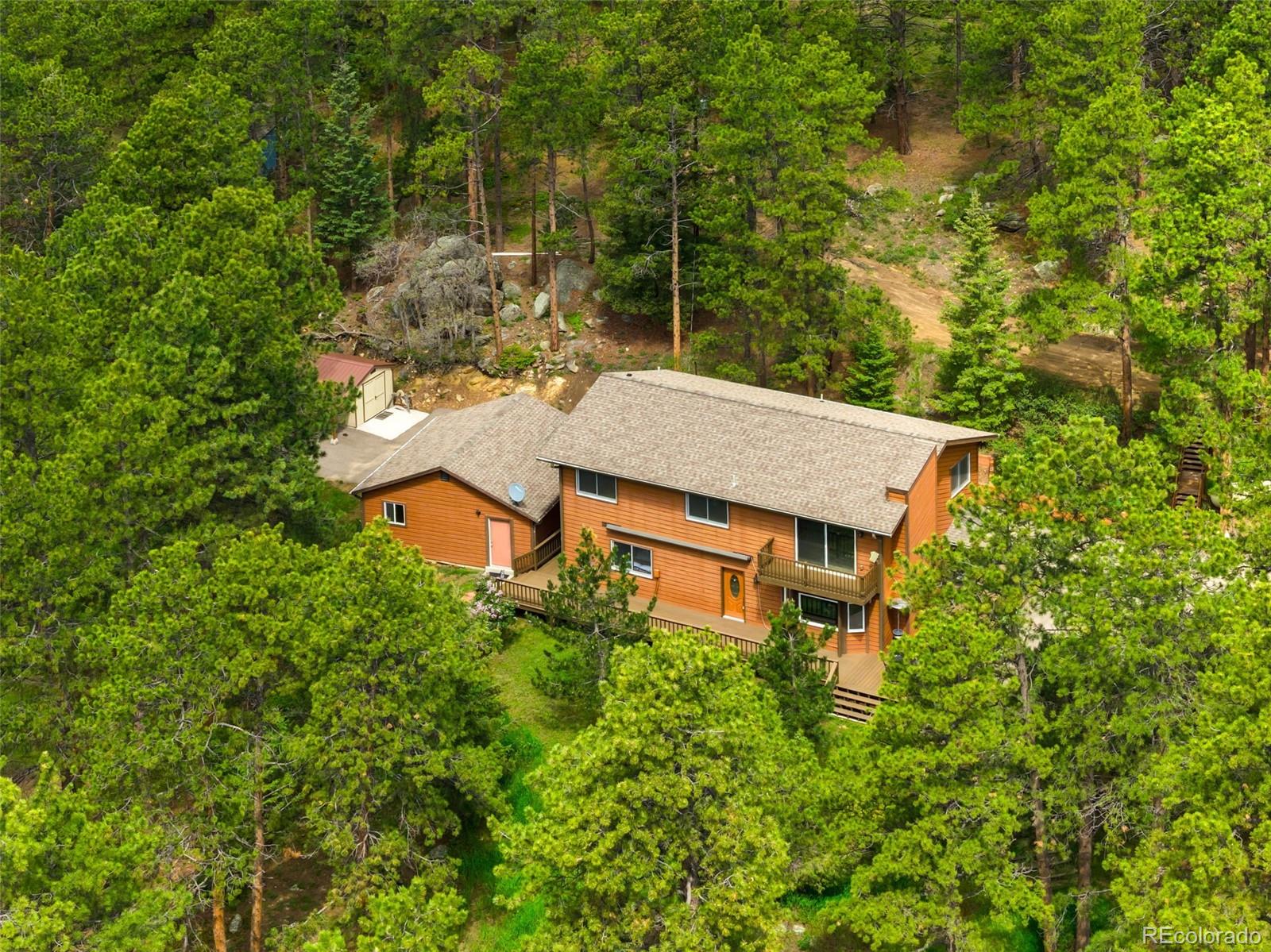 an aerial view of a house with yard and outdoor seating