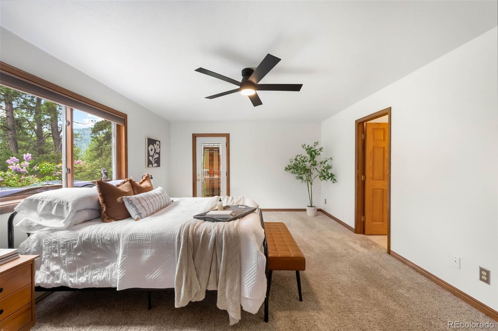 9633 Fox Valley Drive Morrison, CO 80465 - Photo 12 of 50 a bedroom with a bed and a window