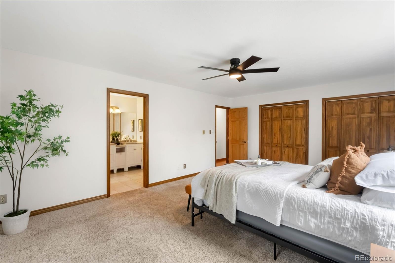 9633 Fox Valley Drive Morrison, CO 80465 - Photo 14 of 50 a bedroom with a bed and a potted plant