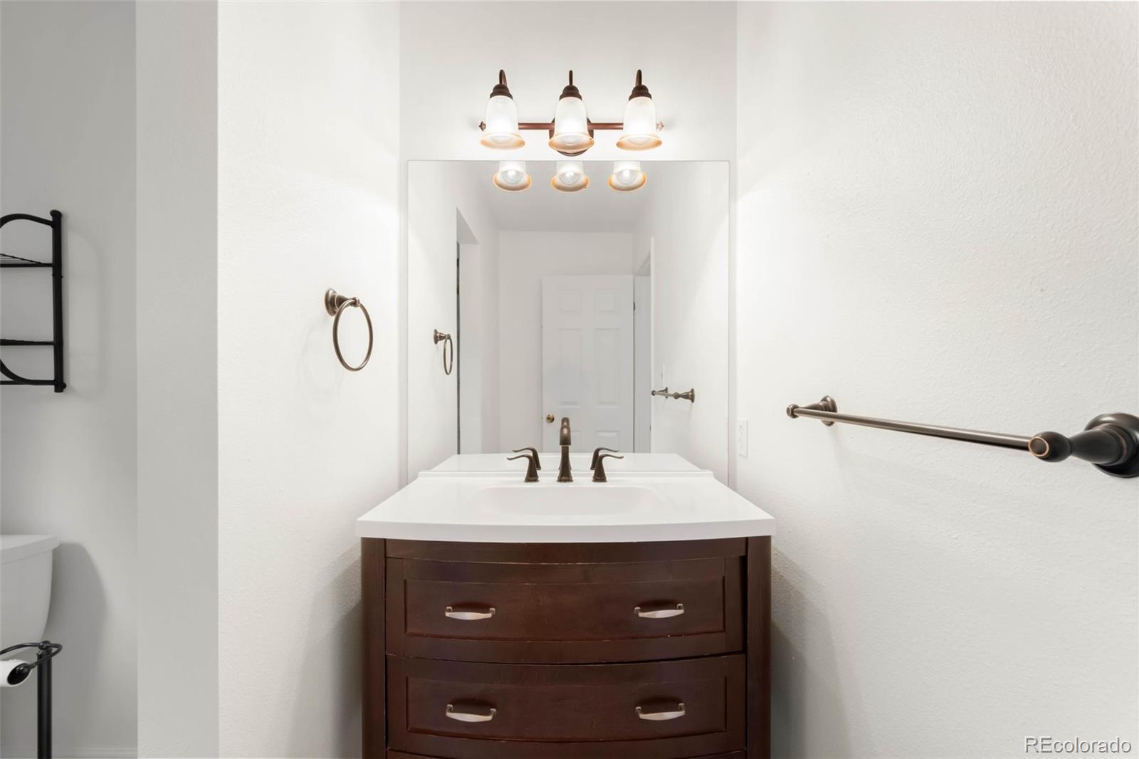 9633 Fox Valley Drive Morrison, CO 80465 - Photo 24 of 50 a bathroom with a sink vanity and a mirror