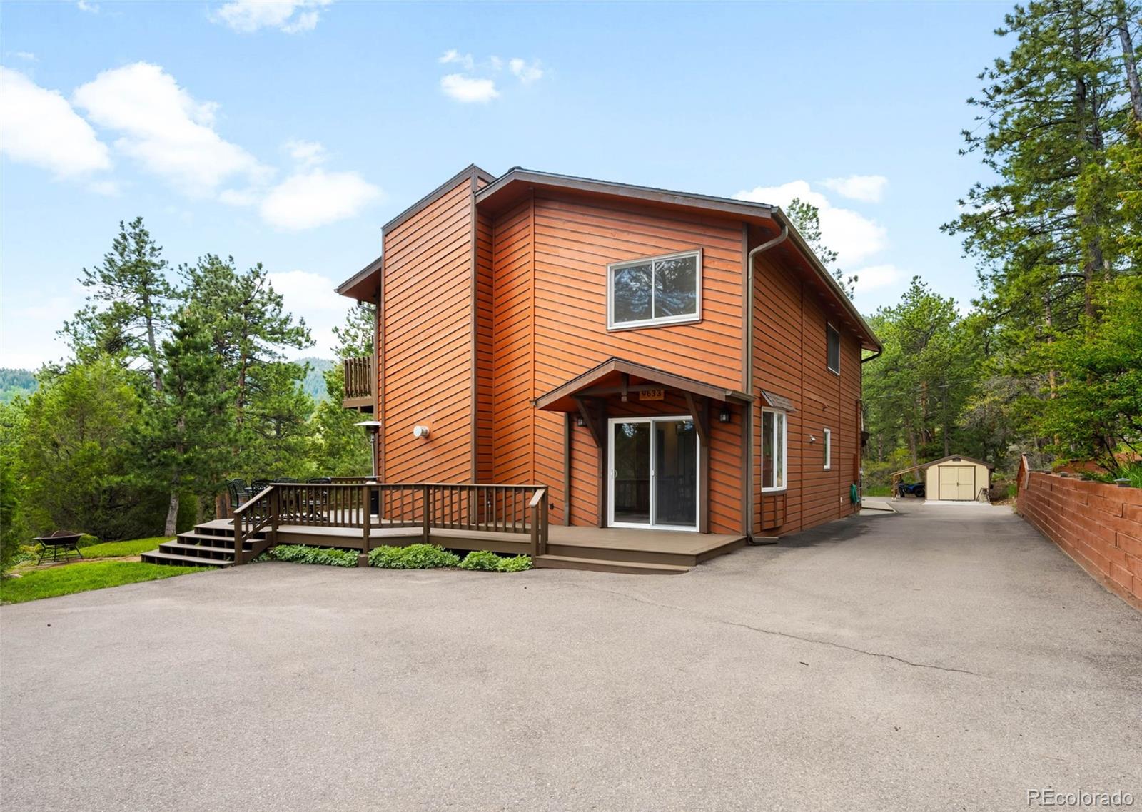 9633 Fox Valley Drive Morrison, CO 80465 - Photo 48 of 50 a front view of a house with a yard