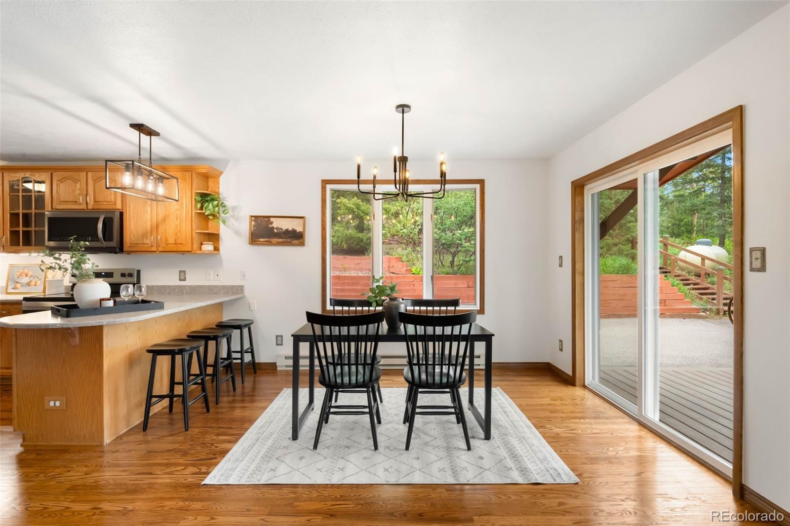 9633 Fox Valley Drive Morrison, CO 80465 - Photo 7 of 50 a dining room with furniture window and wooden floor
