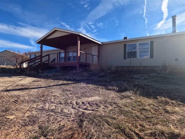 a wooden bench sitting in front of a house