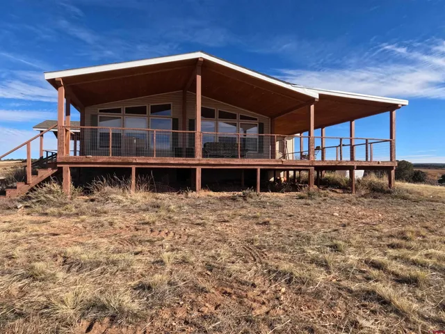 a front view of a house with wooden deck