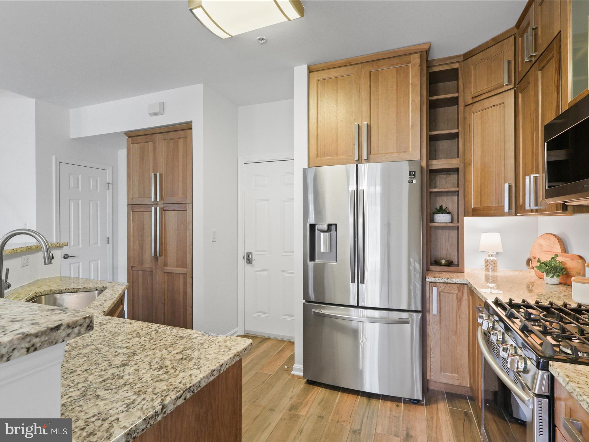 14592 Kylewood Way Gainesville, VA 20155 - Photo 12 of 60 a kitchen with stainless steel appliances granite countertop a refrigerator and a stove top oven
