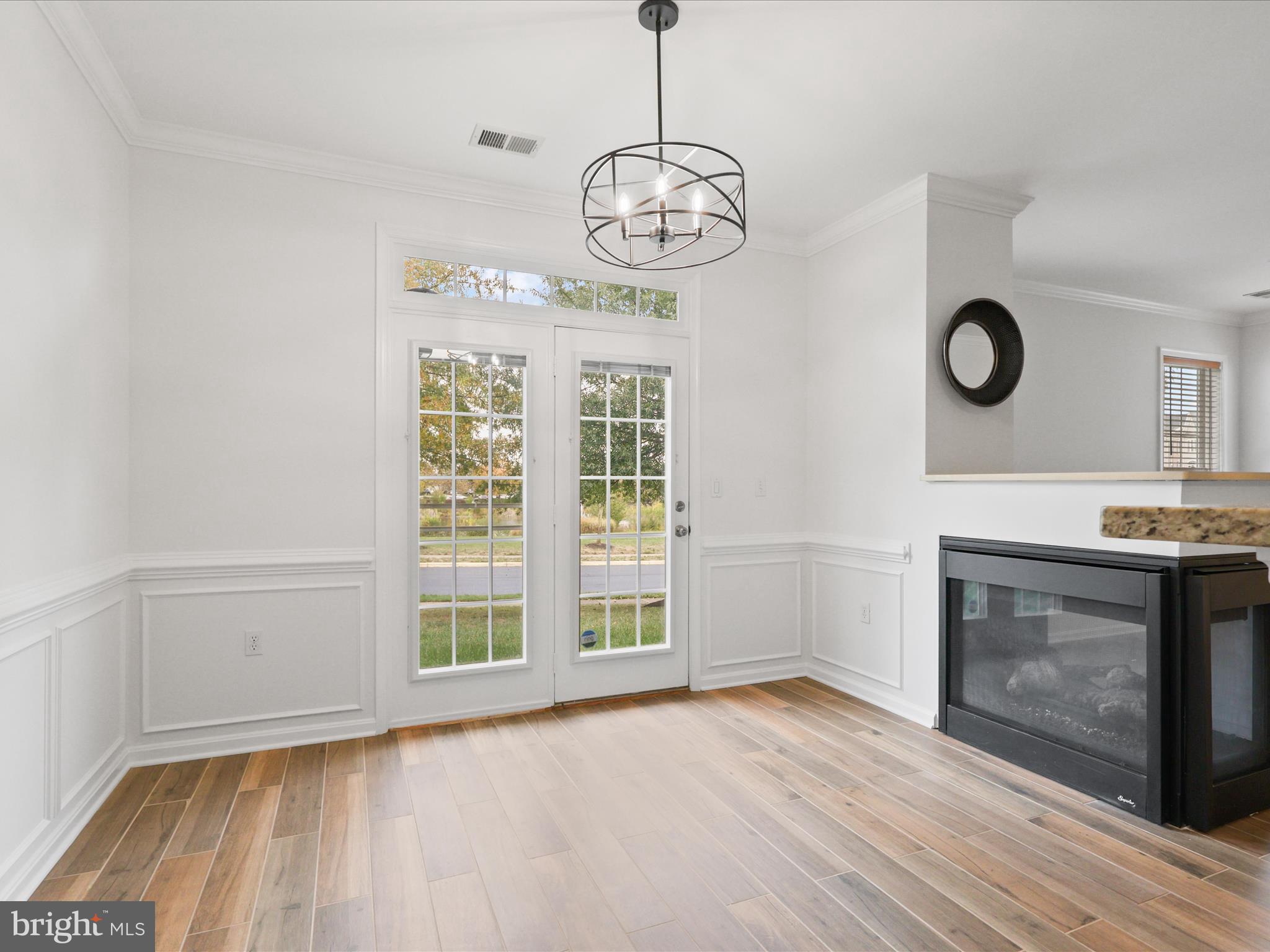 14592 Kylewood Way Gainesville, VA 20155 - Photo 14 of 60 a view of an empty room with wooden floor and a window