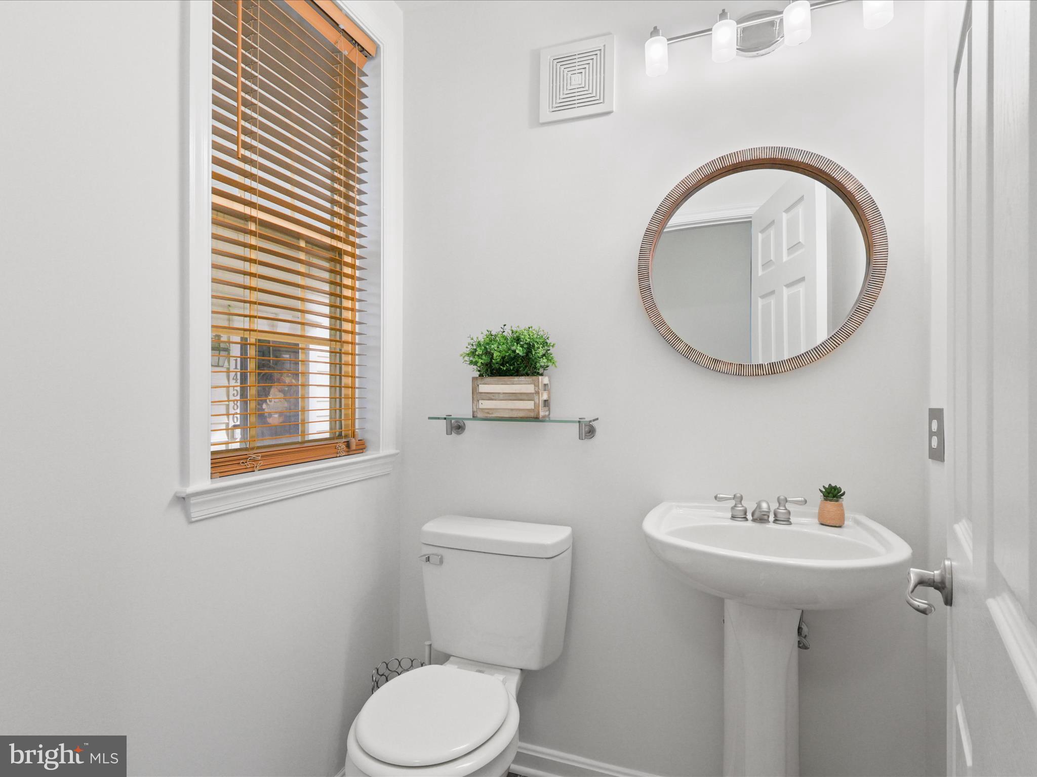 14592 Kylewood Way Gainesville, VA 20155 - Photo 16 of 60 a bathroom with a toilet sink and mirror