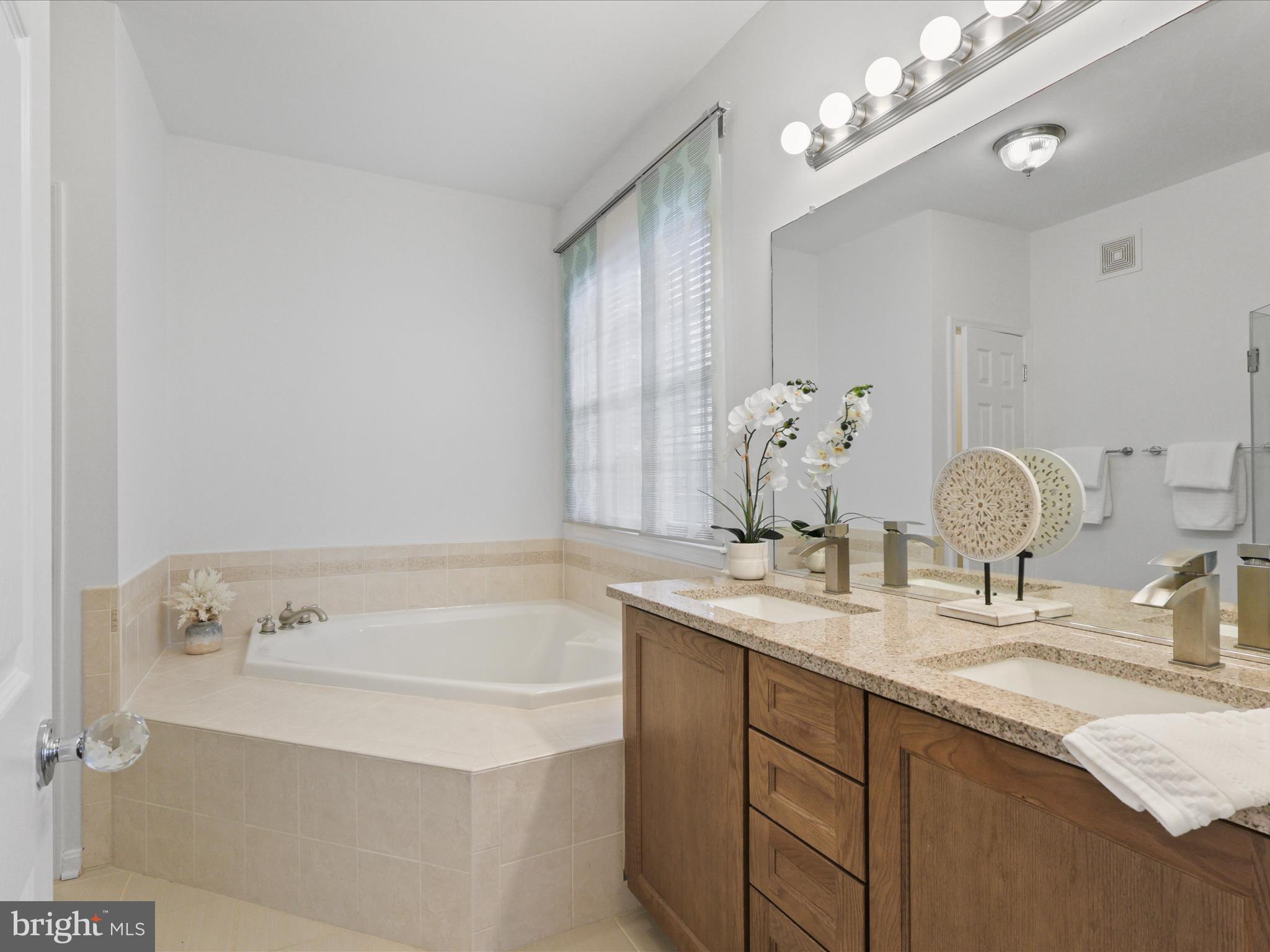14592 Kylewood Way Gainesville, VA 20155 - Photo 22 of 60 a bathroom with a sink double vanity and a mirror