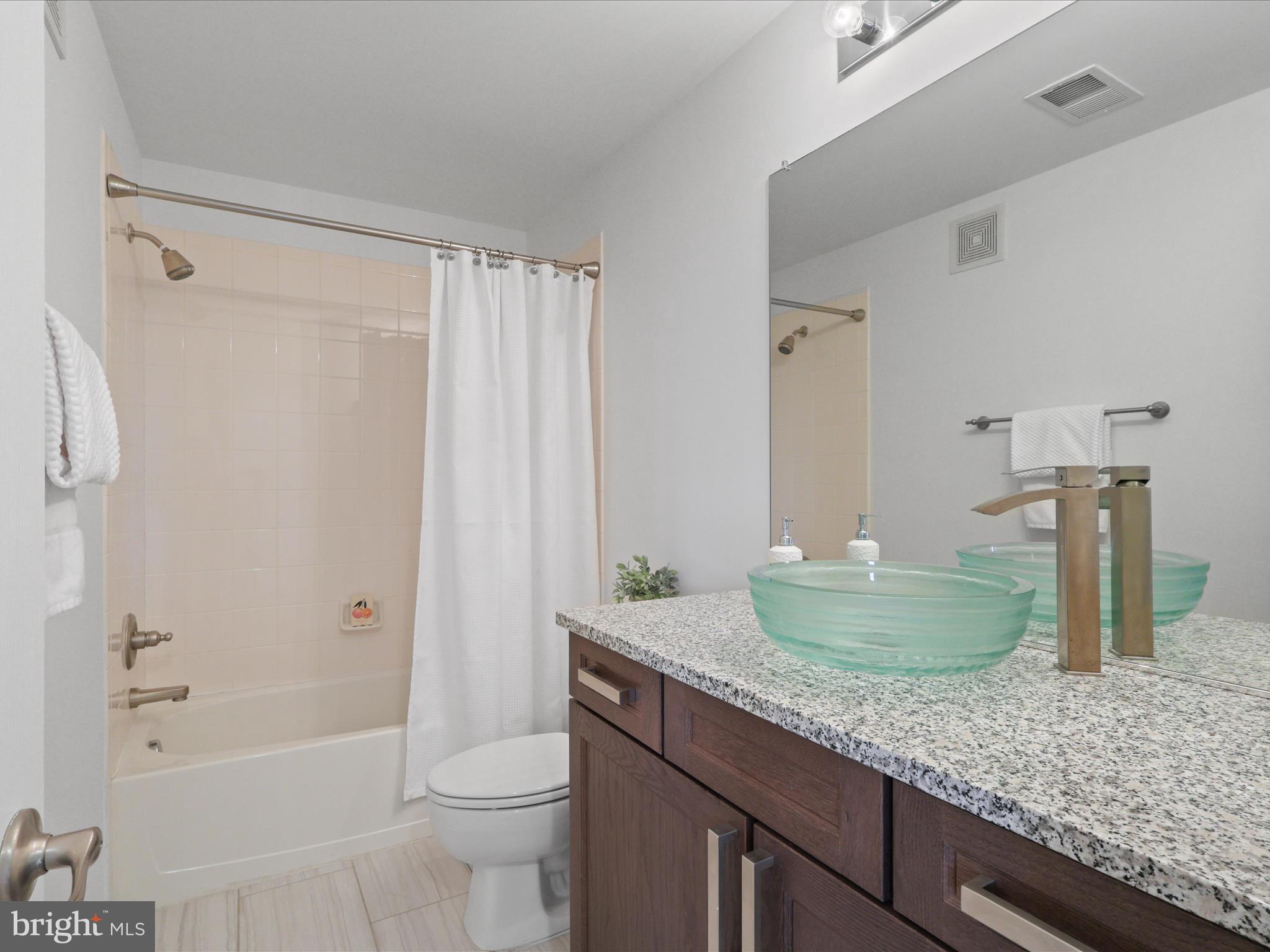 14592 Kylewood Way Gainesville, VA 20155 - Photo 29 of 60 a bathroom with a granite countertop sink toilet and shower
