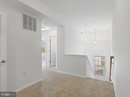a view of a brick house with many windows and plants