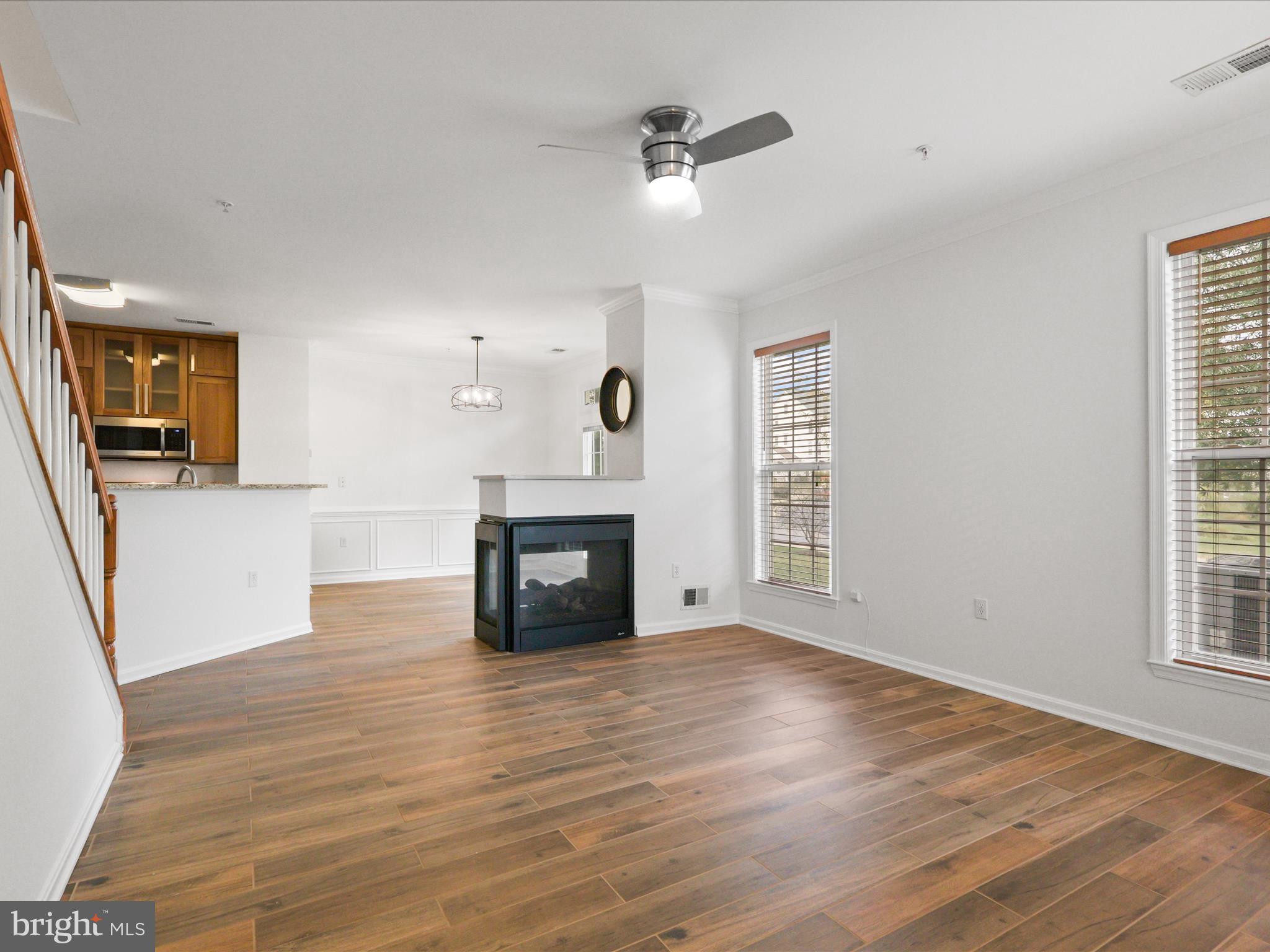 14592 Kylewood Way Gainesville, VA 20155 - Photo 4 of 60 an empty room with wooden floor fireplace and windows