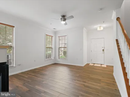 a view of a livingroom with wooden floor and a fireplace