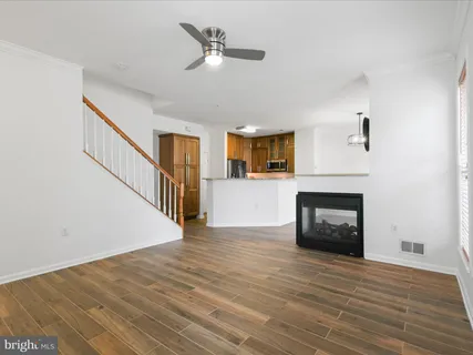 a kitchen with stainless steel appliances granite countertop a sink refrigerator and cabinets