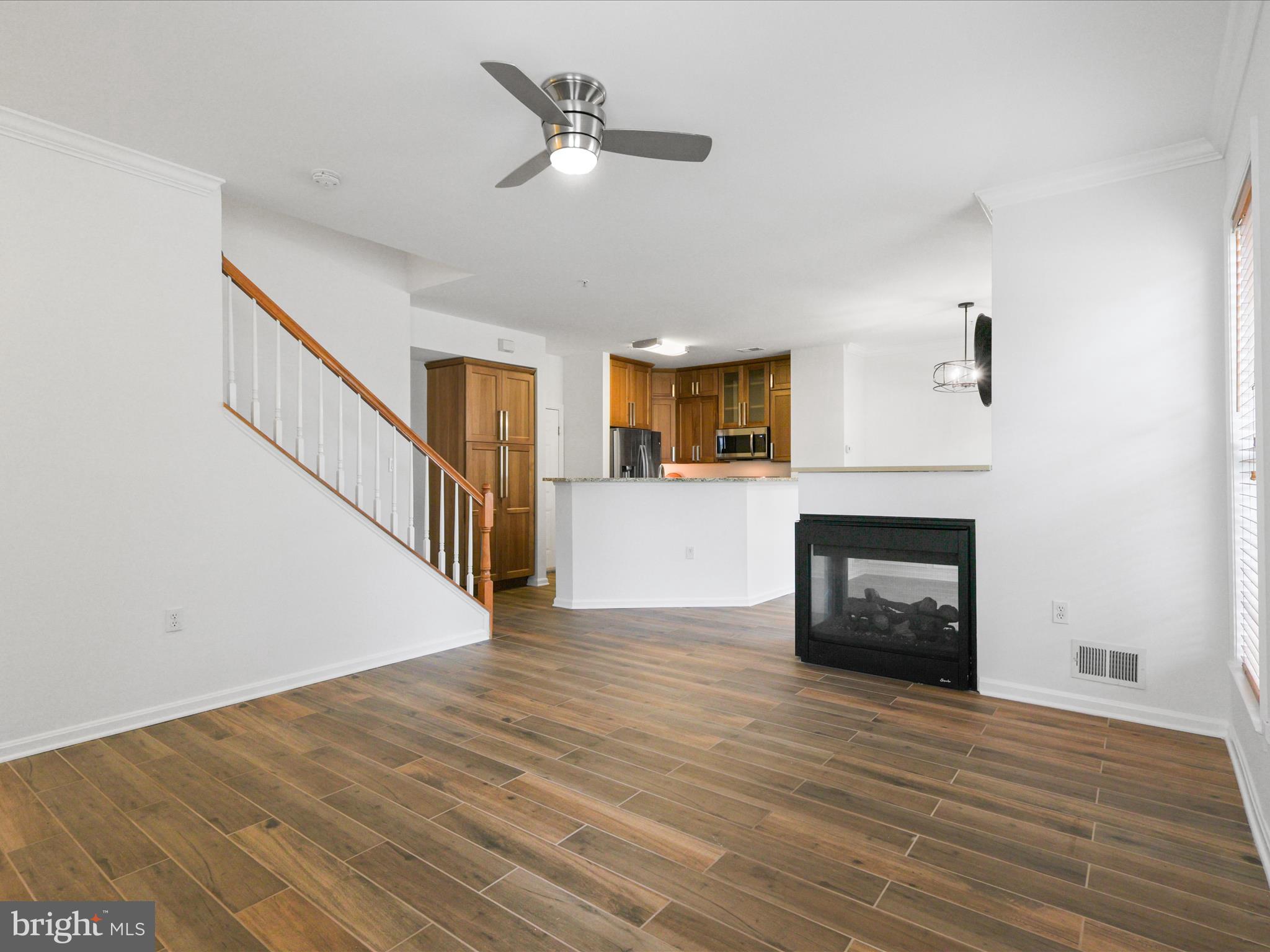 14592 Kylewood Way Gainesville, VA 20155 - Photo 7 of 60 a view of a livingroom with wooden floor and a fireplace