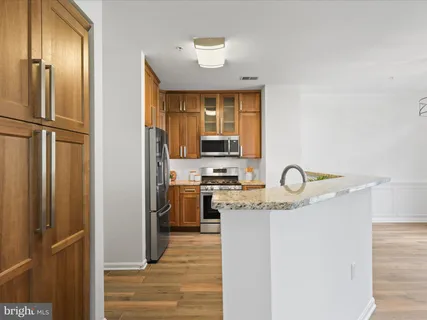 a kitchen with stainless steel appliances granite countertop a stove and a refrigerator