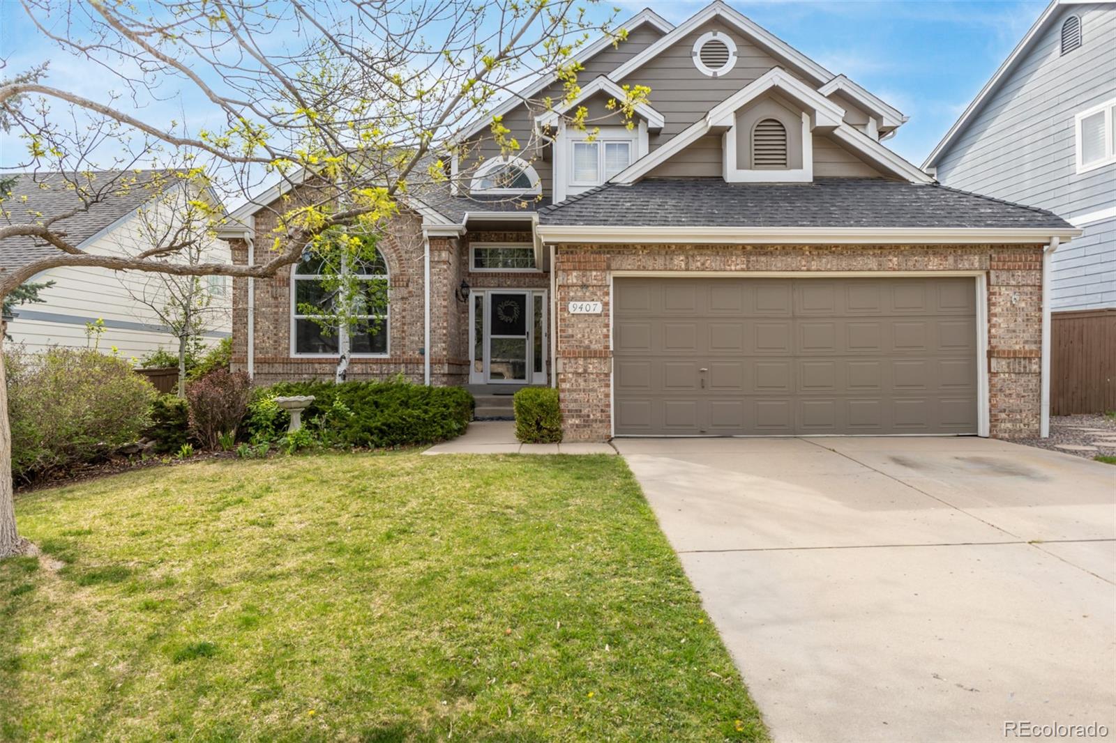 a front view of a house with a yard and garage