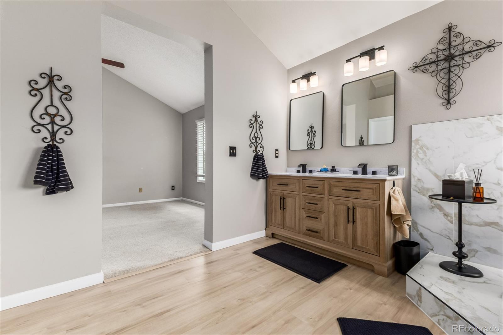 9407 Harvard Drive Highlands Ranch, CO 80130 - Photo 19 of 48 a bathroom with a double vanity sink and a mirror