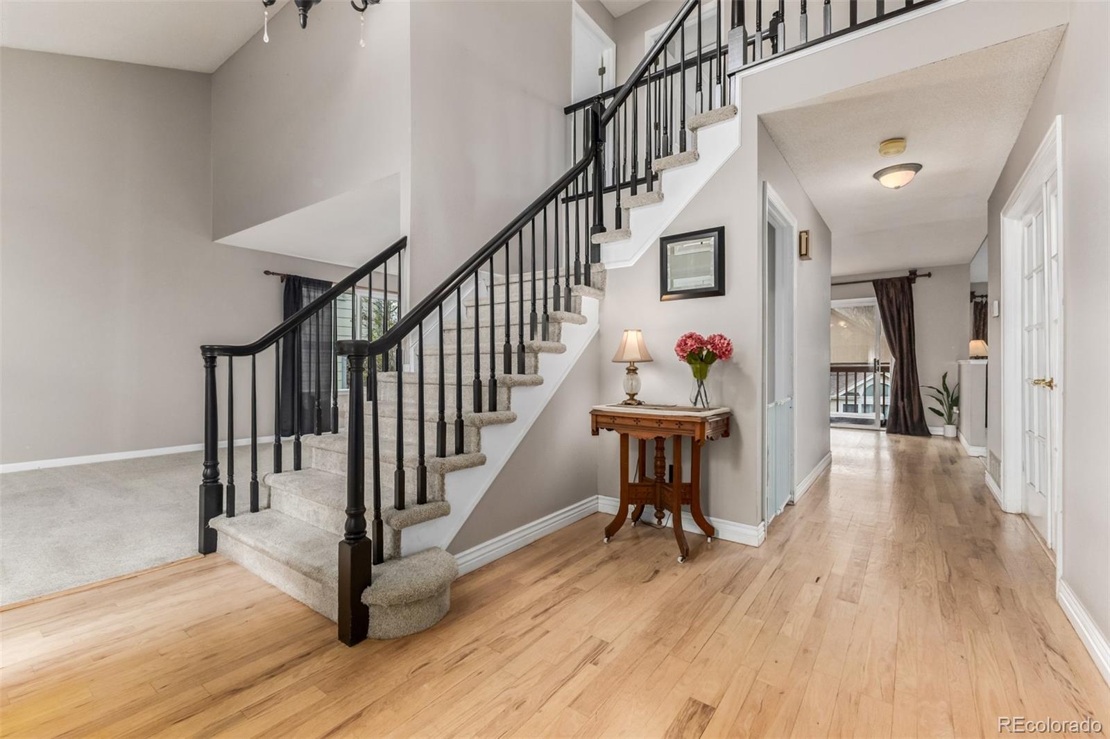 9407 Harvard Drive Highlands Ranch, CO 80130 - Photo 2 of 48 a view of staircase with wooden floor and a rug