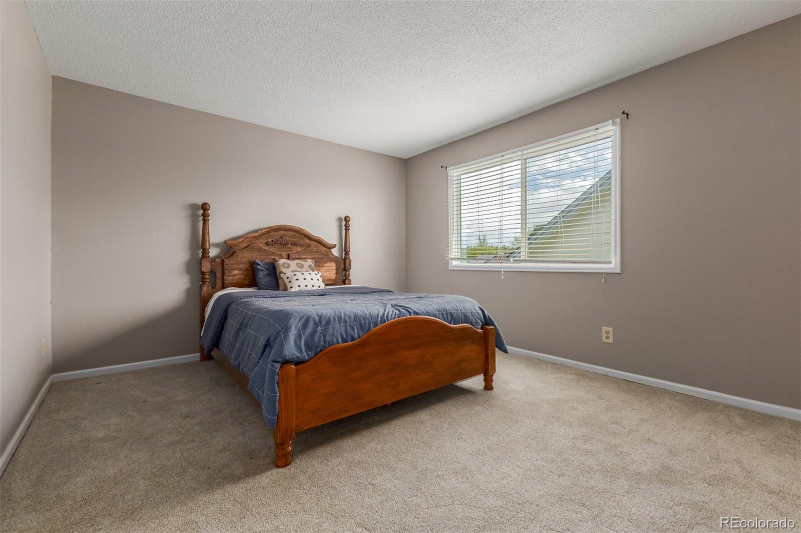 9407 Harvard Drive Highlands Ranch, CO 80130 - Photo 21 of 48 a bedroom with a bed and window