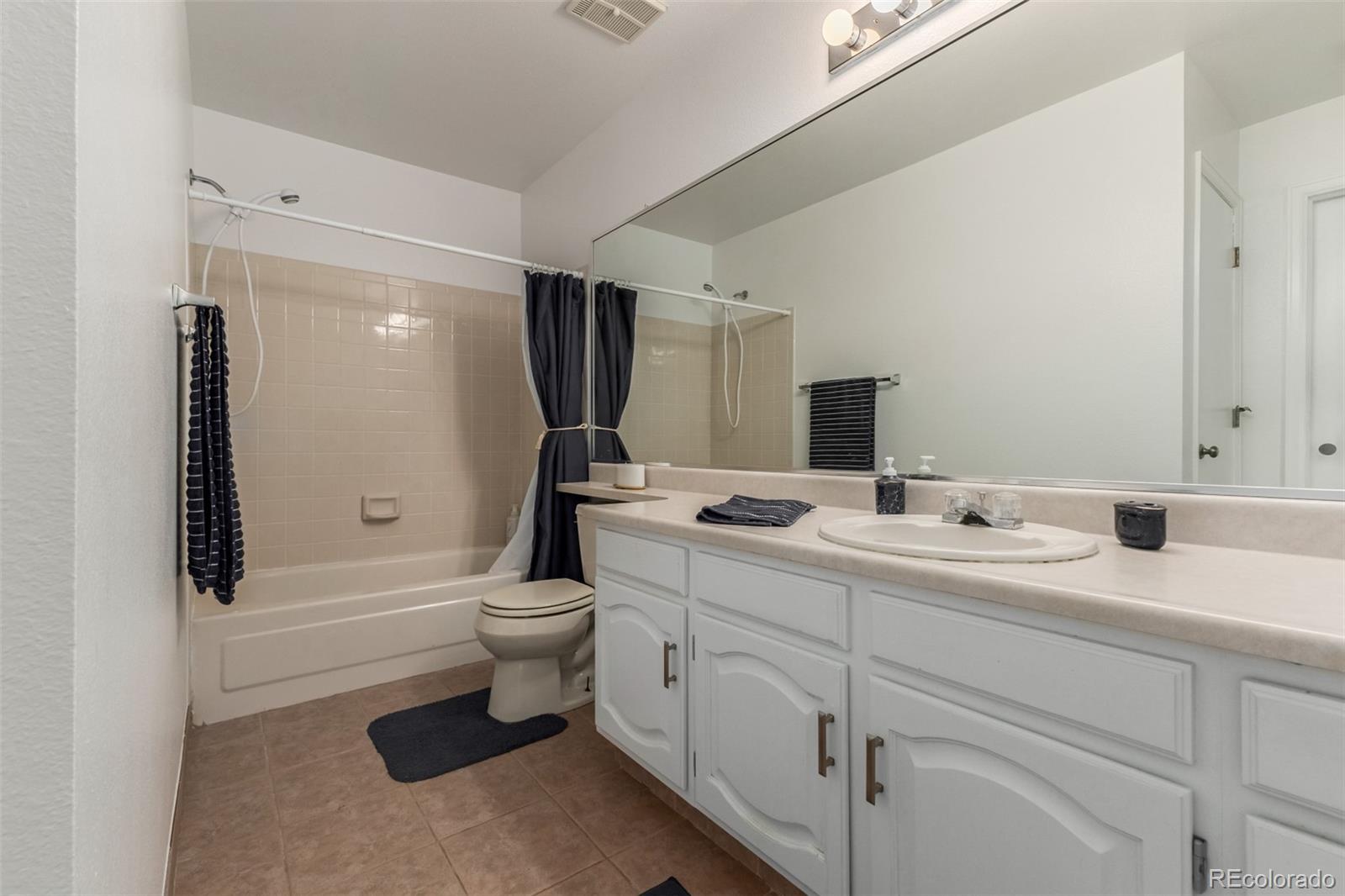 9407 Harvard Drive Highlands Ranch, CO 80130 - Photo 22 of 48 a bathroom with a double vanity sink toilet and shower