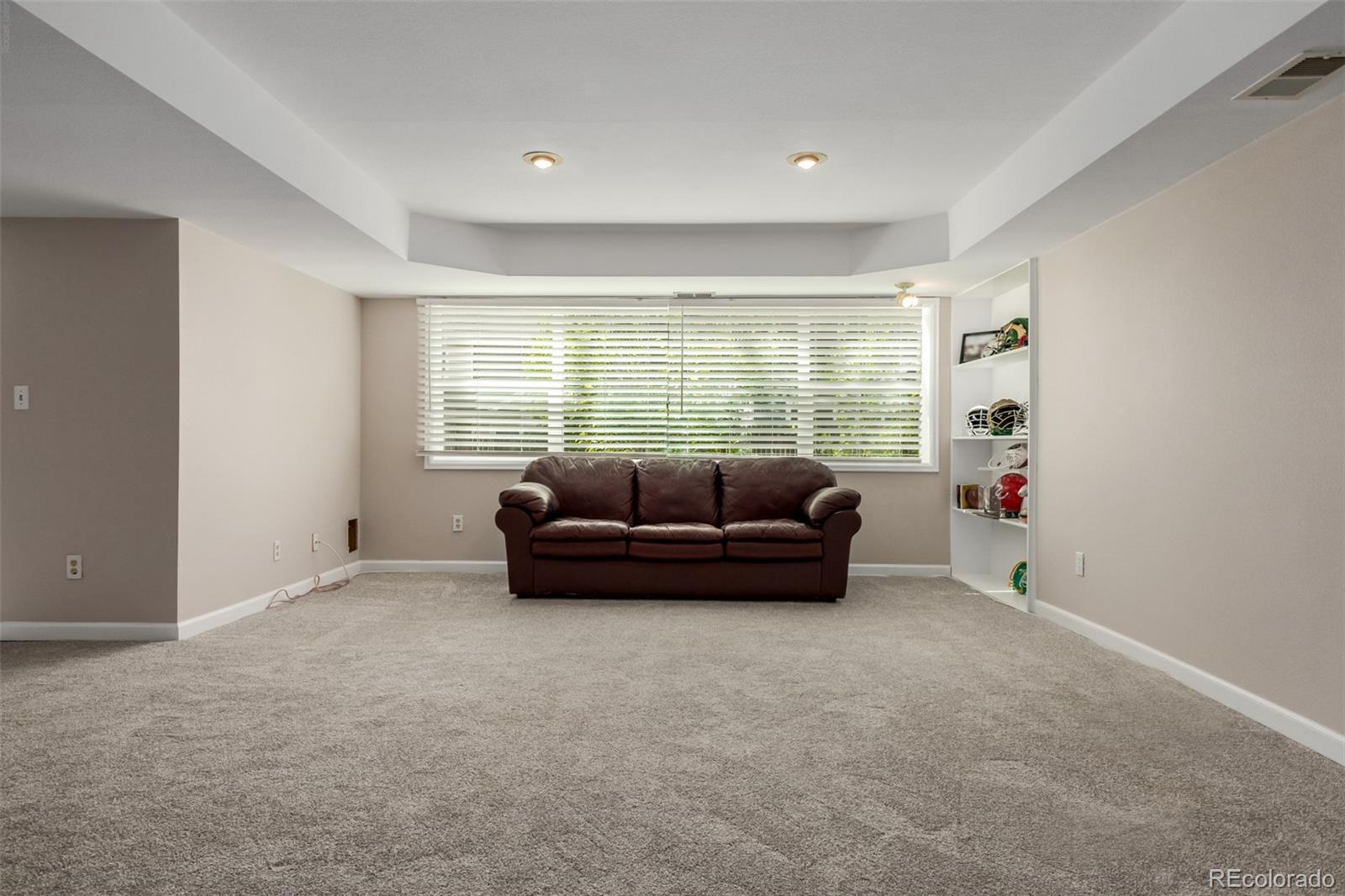 9407 Harvard Drive Highlands Ranch, CO 80130 - Photo 28 of 48 a living room with furniture and a window