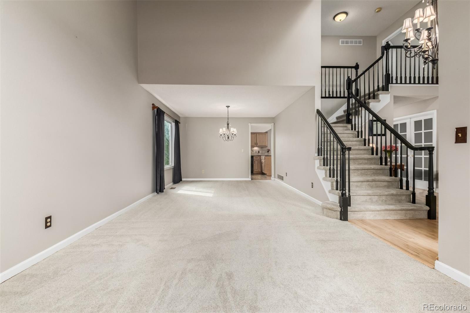 9407 Harvard Drive Highlands Ranch, CO 80130 - Photo 3 of 48 a view of a hallway with staircase