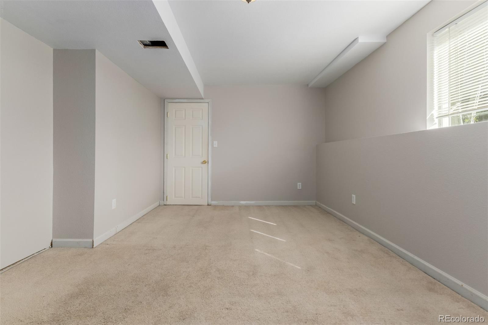 9407 Harvard Drive Highlands Ranch, CO 80130 - Photo 32 of 48 a view of an empty room with a window
