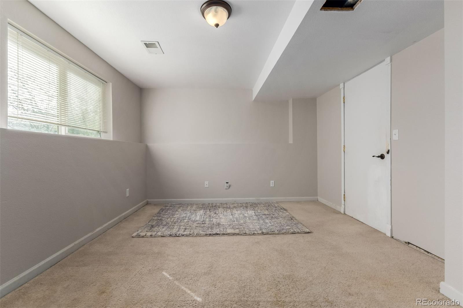 9407 Harvard Drive Highlands Ranch, CO 80130 - Photo 38 of 48 an empty room with windows