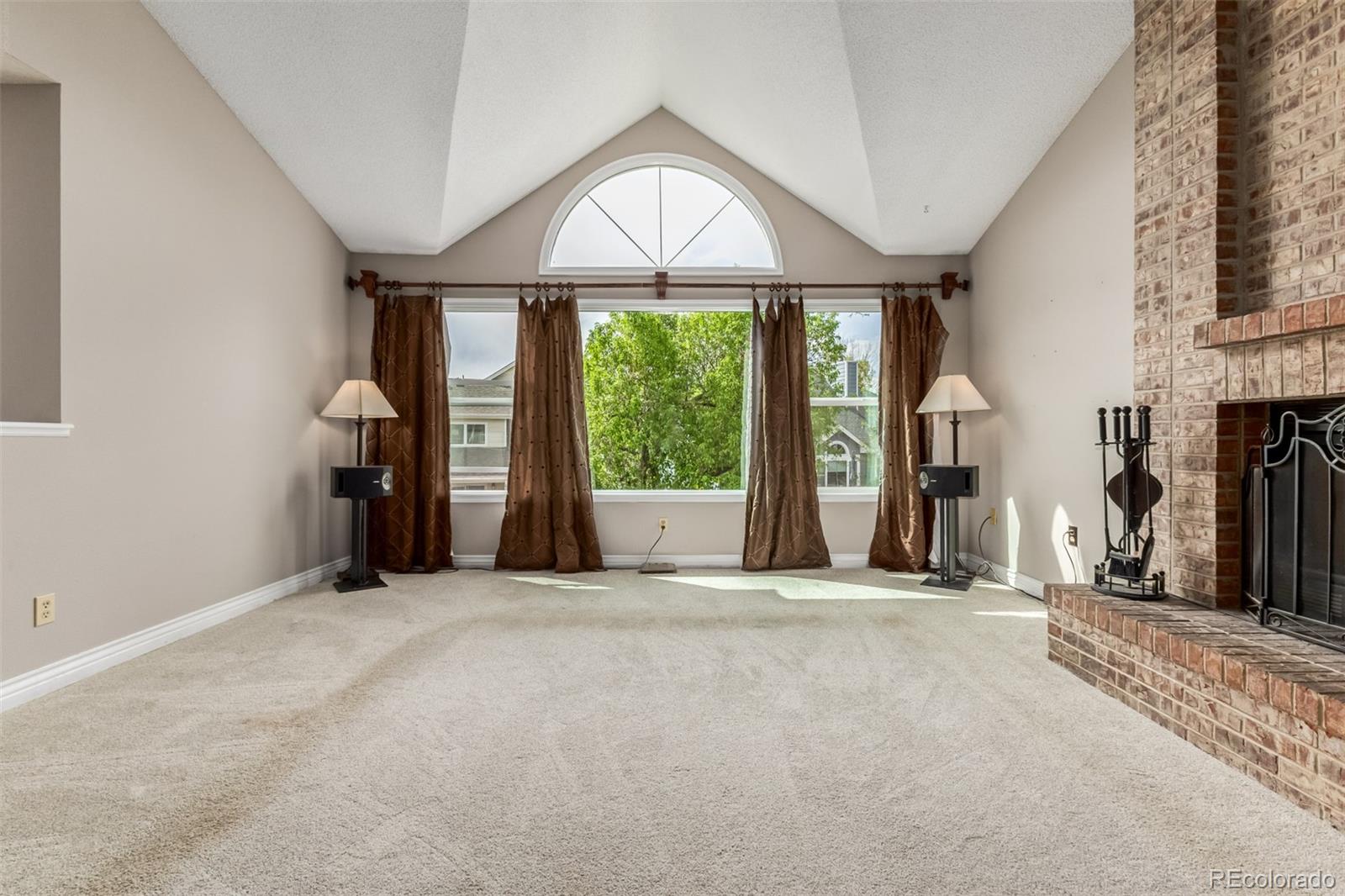 9407 Harvard Drive Highlands Ranch, CO 80130 - Photo 5 of 48 an empty room with fireplace and windows