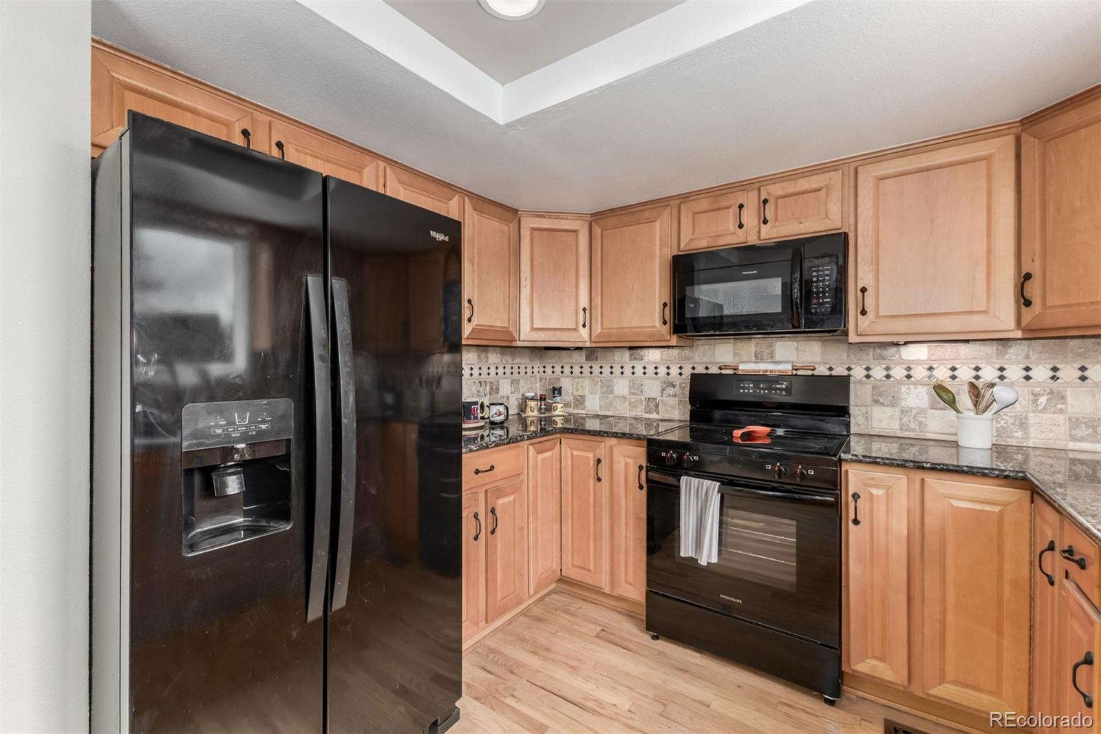 9407 Harvard Drive Highlands Ranch, CO 80130 - Photo 10 of 48 a kitchen with a refrigerator stove and sink