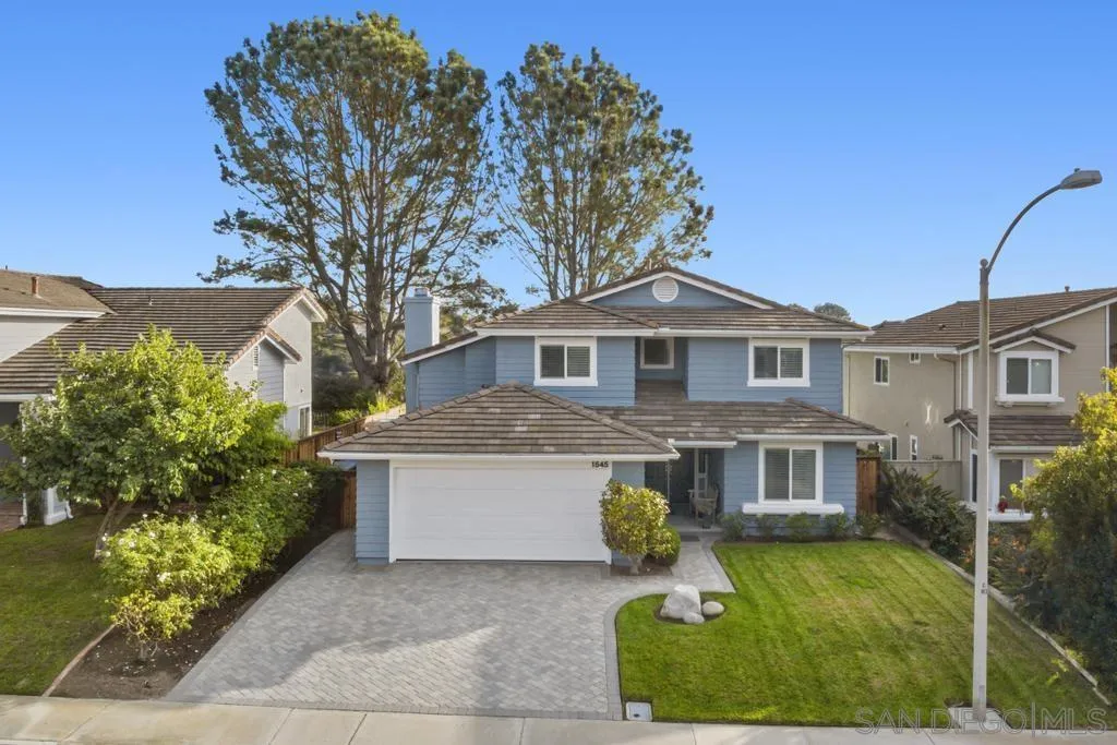 1545 Calle Ryan Encinitas, CA 92024 - Photo 11 of 63 a front view of a house with a yard and garage