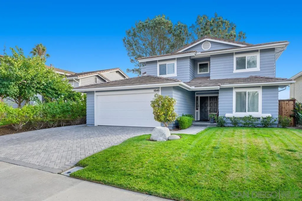 1545 Calle Ryan Encinitas, CA 92024 - Photo 2 of 63 a front view of a house with a garden and yard