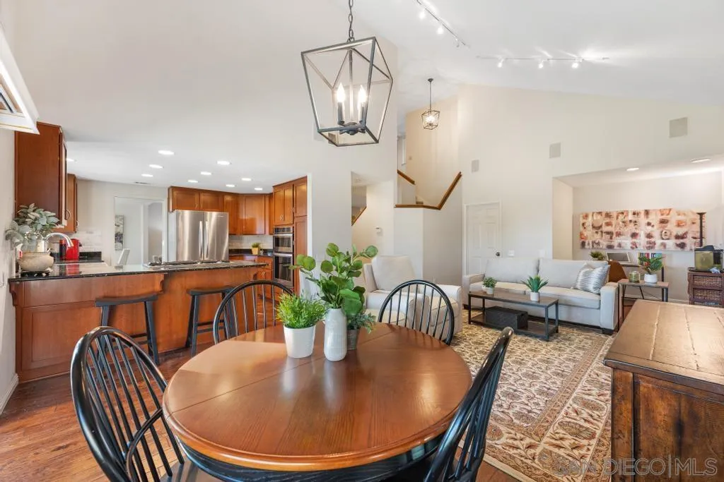 1545 Calle Ryan Encinitas, CA 92024 - Photo 28 of 63 a dining room with furniture potted plants and wooden floor