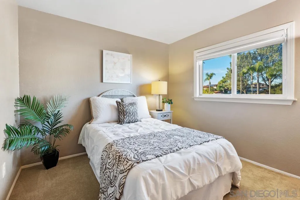 1545 Calle Ryan Encinitas, CA 92024 - Photo 41 of 63 a bedroom with a bed and a potted plant