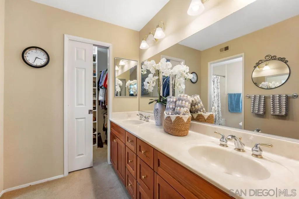 1545 Calle Ryan Encinitas, CA 92024 - Photo 49 of 63 a spacious bathroom with a granite countertop sink and a mirror