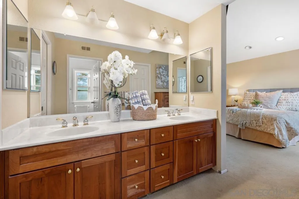 1545 Calle Ryan Encinitas, CA 92024 - Photo 50 of 63 a spacious bathroom with a double vanity sink and a mirror
