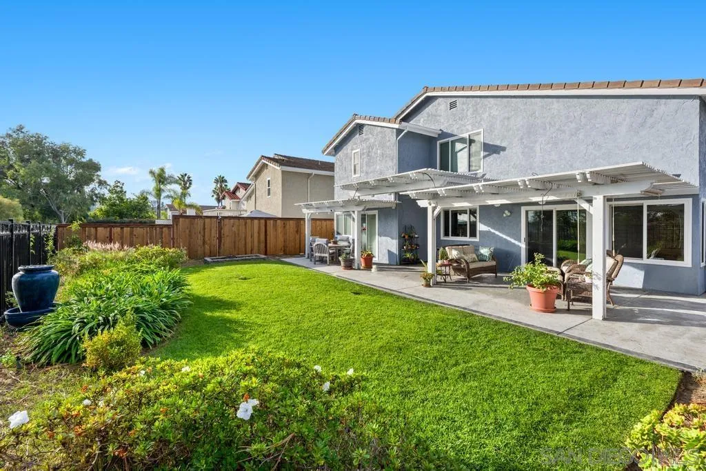 1545 Calle Ryan Encinitas, CA 92024 - Photo 7 of 63 a view of a yard with table and chairs under an umbrella