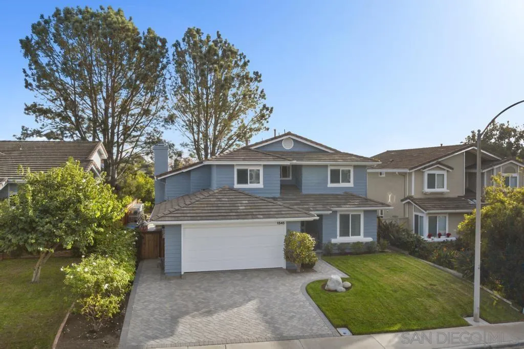 1545 Calle Ryan Encinitas, CA 92024 - Photo 10 of 63 a front view of a house with a garden