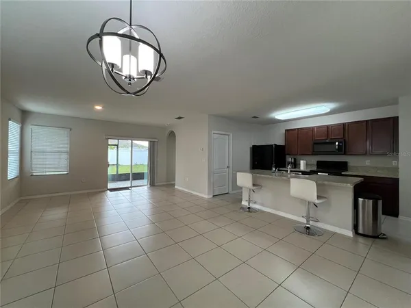 a kitchen with stainless steel appliances granite countertop a sink and a refrigerator